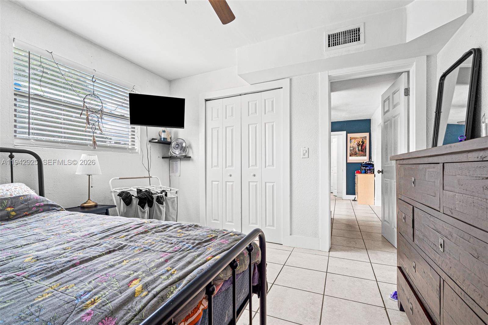 5844 Garfield Street Hollywood, FL 33021 - Photo 17 of 31 a room with a bed and a flat screen tv