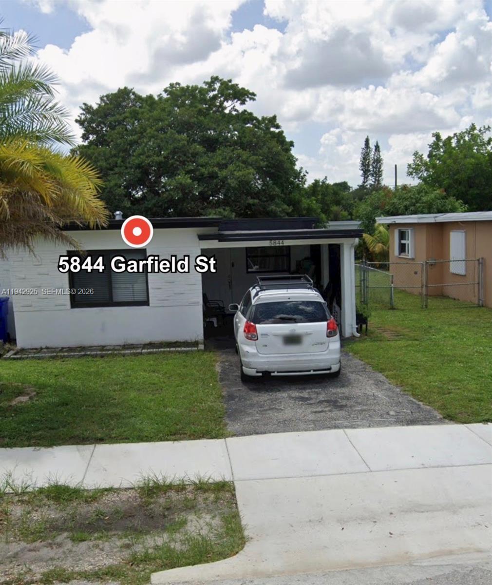 5844 Garfield Street Hollywood, FL 33021 - Photo 2 of 31 a view of street with parked cars