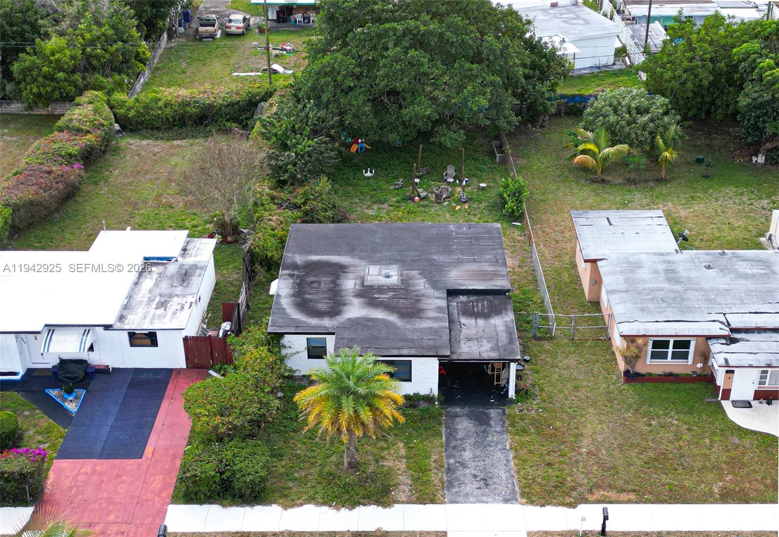 5844 Garfield Street Hollywood, FL 33021 - Photo 4 of 31 an aerial view of multiple houses with a yard