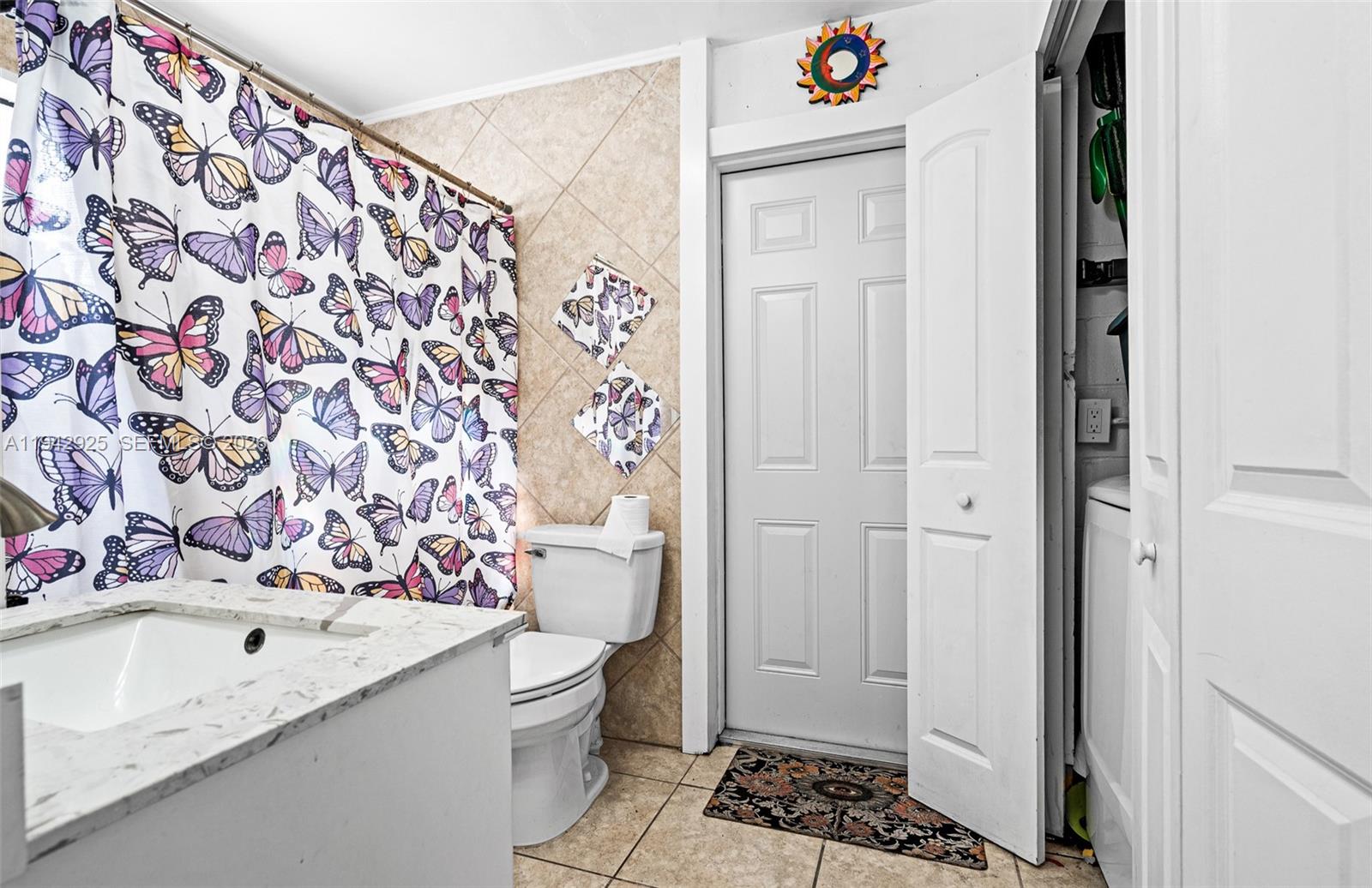 5844 Garfield Street Hollywood, FL 33021 - Photo 6 of 31 a bathroom with a sink and mirror with toilet