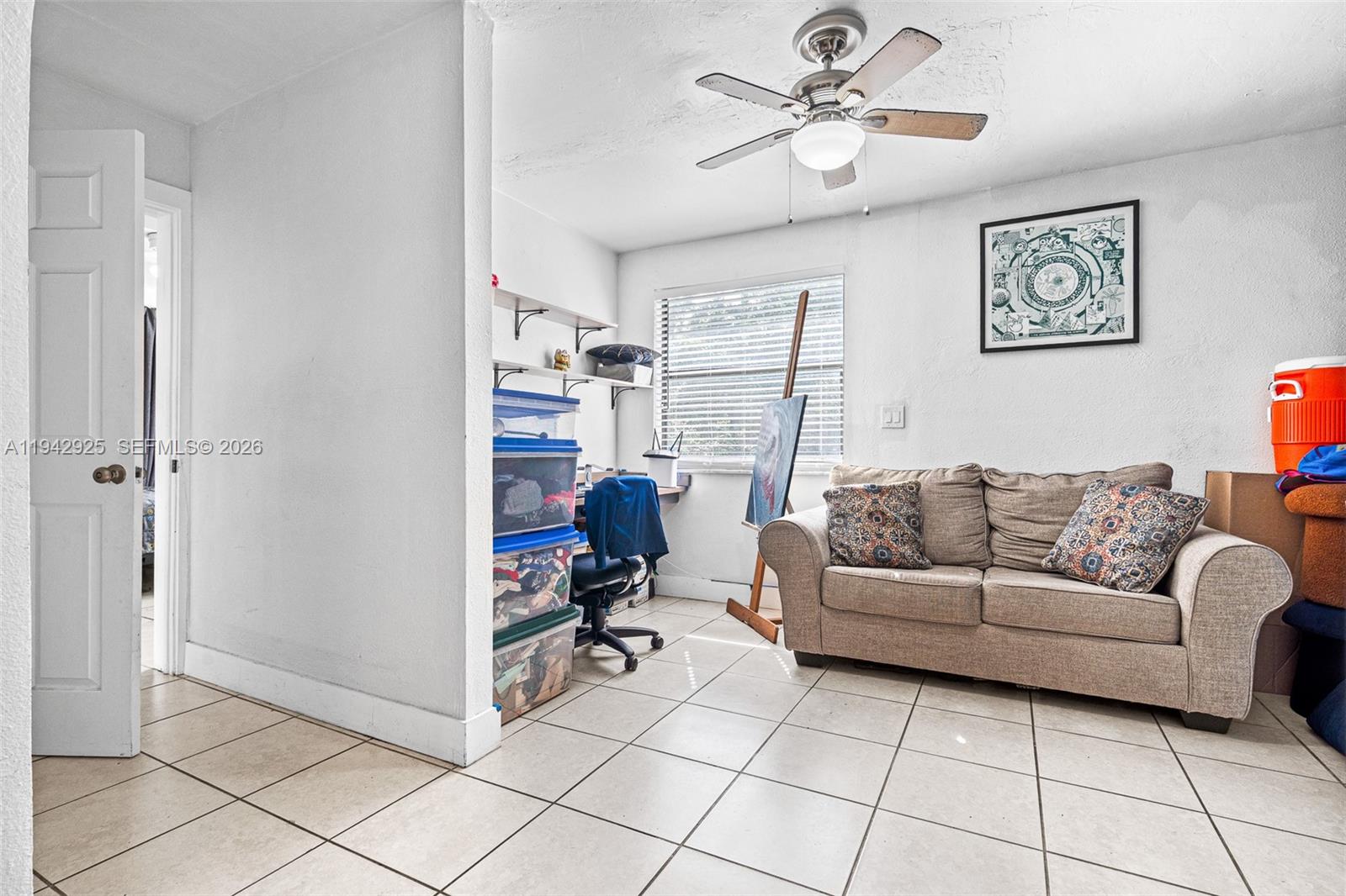 5844 Garfield Street Hollywood, FL 33021 - Photo 8 of 31 a living room with furniture and a chandelier