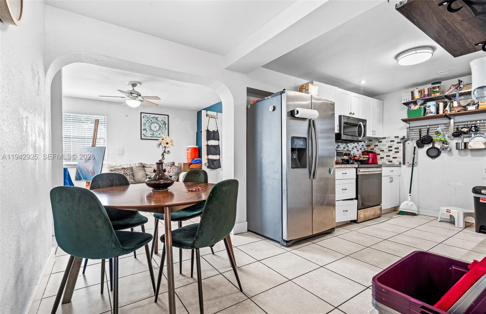 5844 Garfield Street Hollywood, FL 33021 - Photo 10 of 31 a view of a dining room with furniture and a chandelier