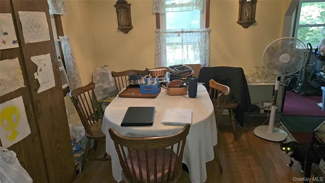 a dining room with furniture and window