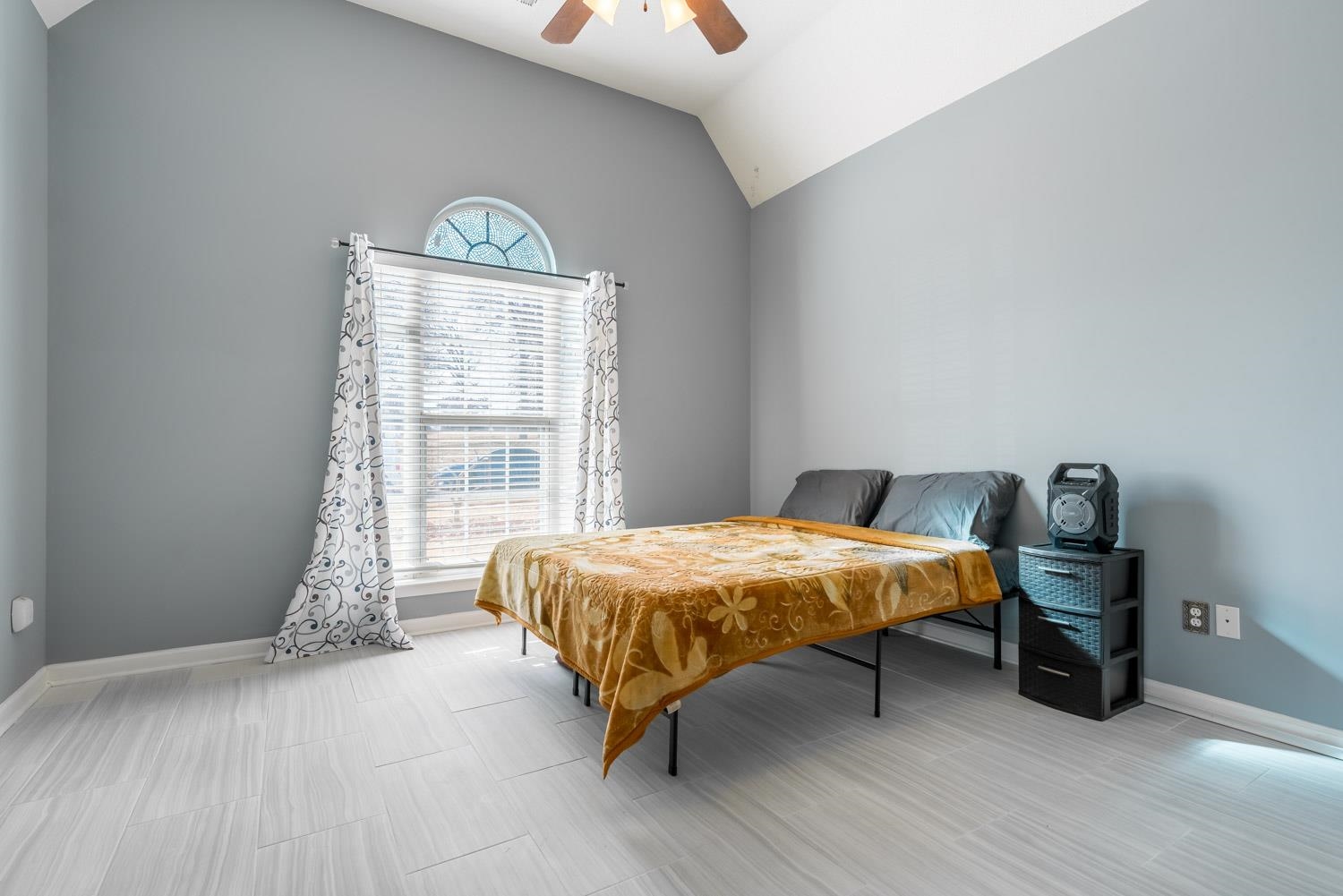 6818 Manslick Road Cordova, TN 38018 - Photo 15 of 23 a bed sitting in a bedroom next to a window