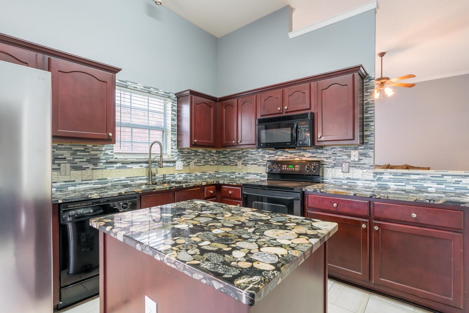 6818 Manslick Road Cordova, TN 38018 - Photo 10 of 23 a kitchen with stainless steel appliances granite countertop a stove top oven a sink and dishwasher a oven with wooden cabinets