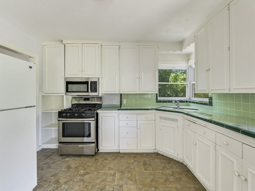 2323 Hartford Road, Unit A Austin, TX 78703 - Photo 7 of 15 Ample cabinetry and tile countertops maximize preparation space in this functional layout.
