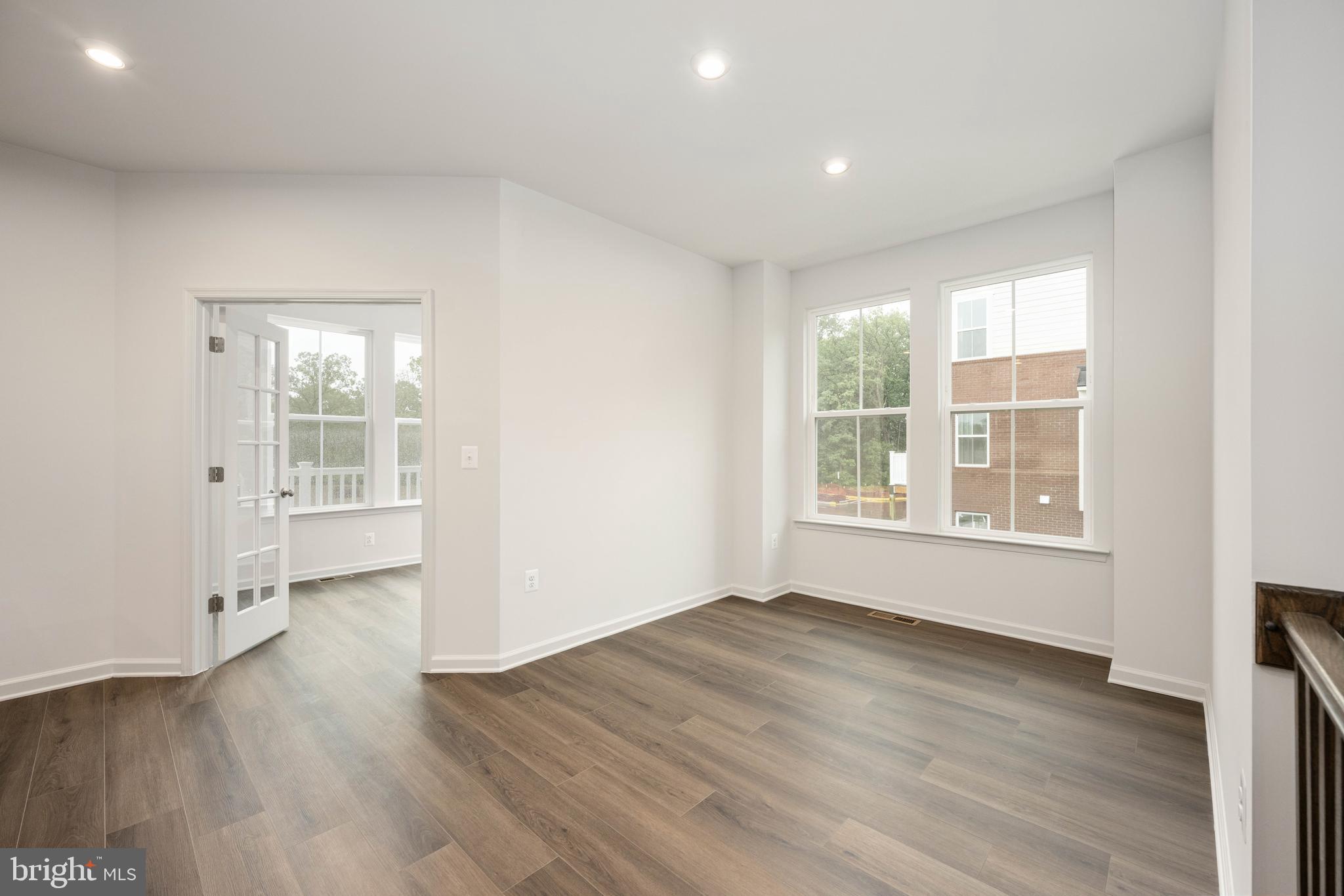 10114 Queens Way Manassas, VA 20110 - Photo 13 of 56 an empty room with wooden floor and windows
