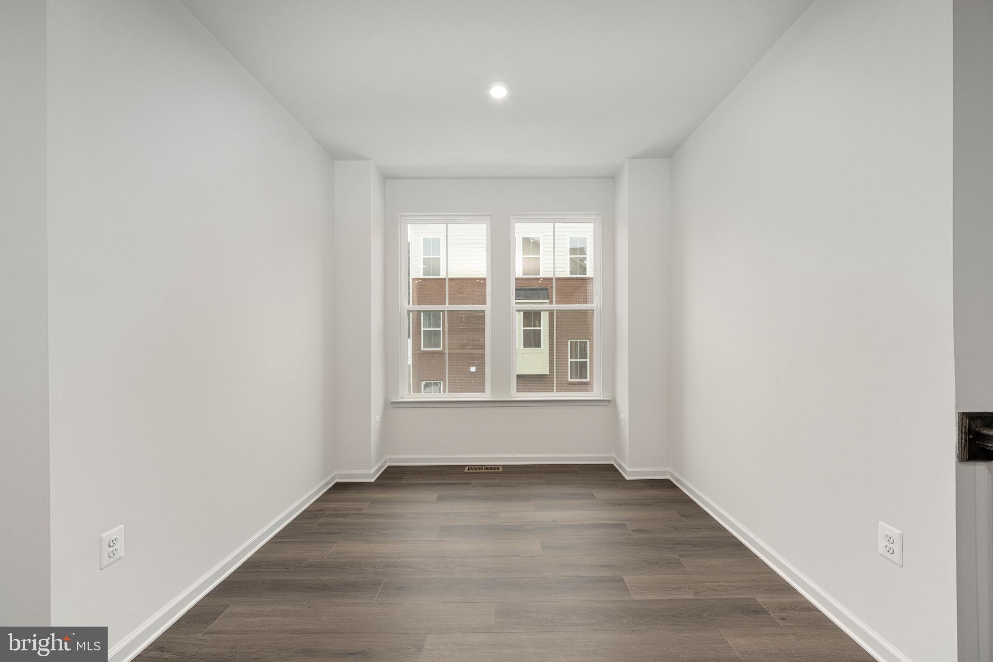 10114 Queens Way Manassas, VA 20110 - Photo 14 of 56 an empty room with wooden floor and windows
