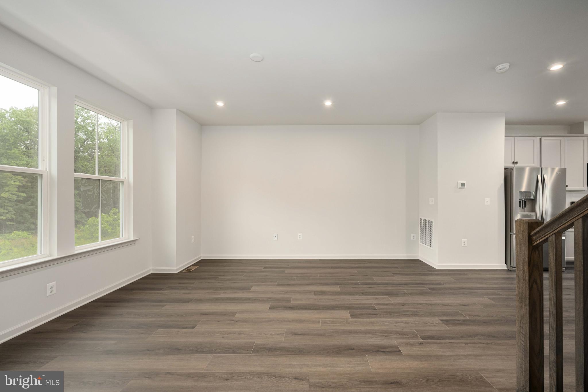 10114 Queens Way Manassas, VA 20110 - Photo 19 of 56 a view of empty room with wooden floor and fan