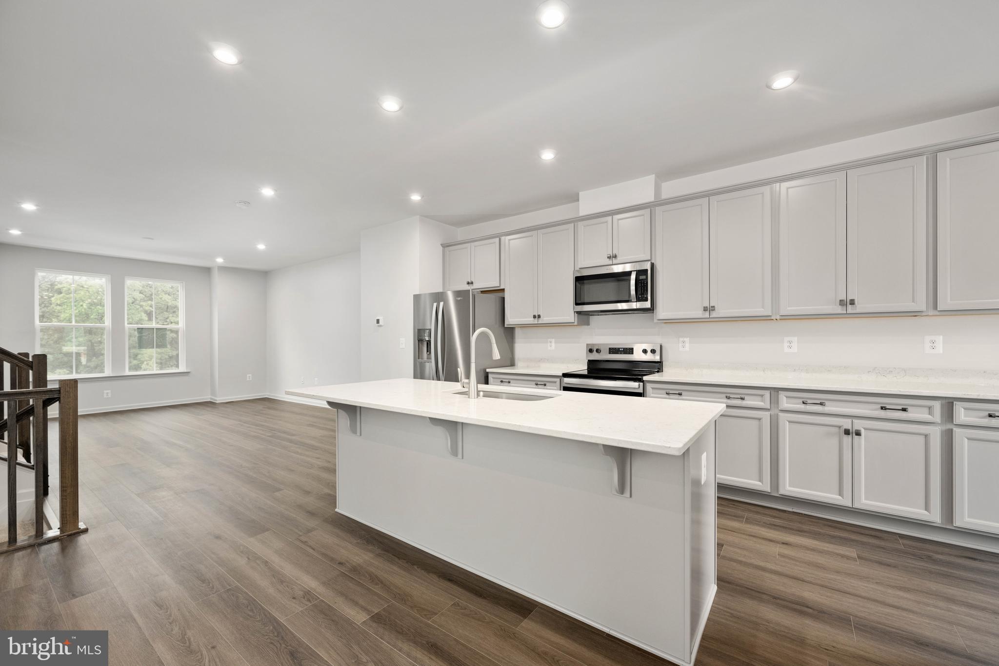 10114 Queens Way Manassas, VA 20110 - Photo 21 of 56 a kitchen with stainless steel appliances granite countertop a sink dishwasher a stove and a refrigerator with wooden floor
