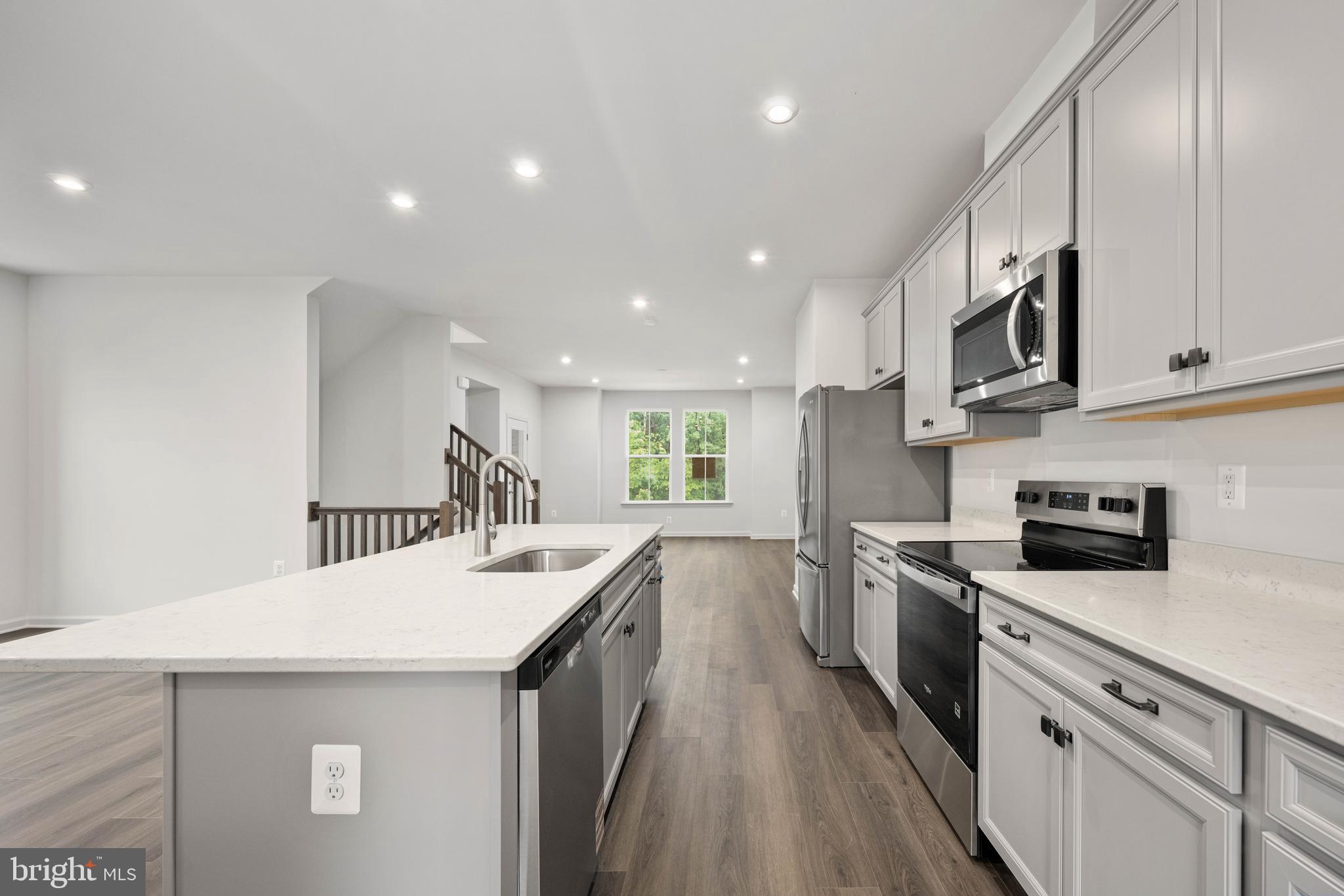 10114 Queens Way Manassas, VA 20110 - Photo 26 of 56 a kitchen with granite countertop a sink a counter top space stainless steel appliances and cabinets