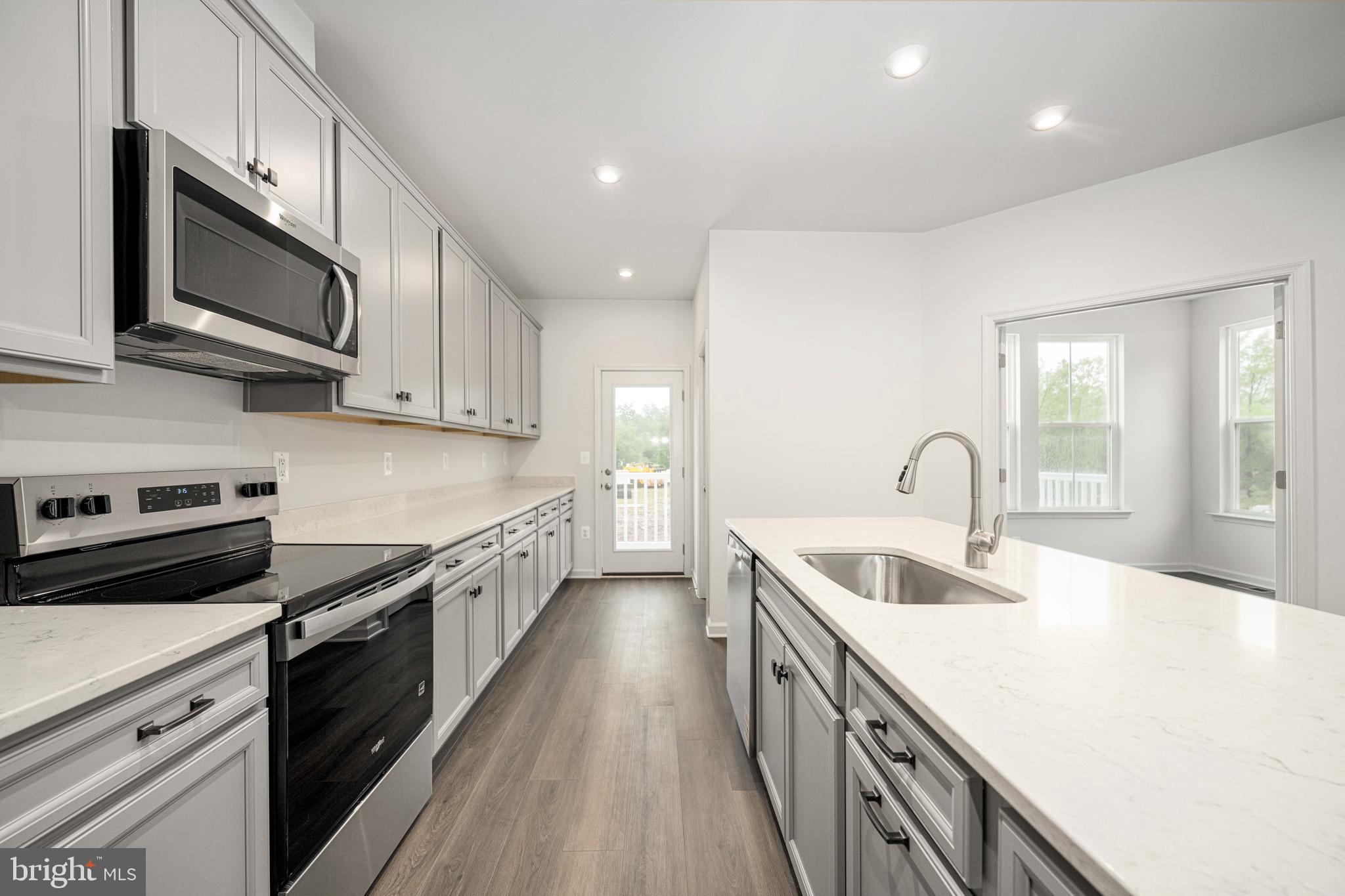 10114 Queens Way Manassas, VA 20110 - Photo 28 of 56 a kitchen with stainless steel appliances granite countertop a sink a stove top oven and white cabinets