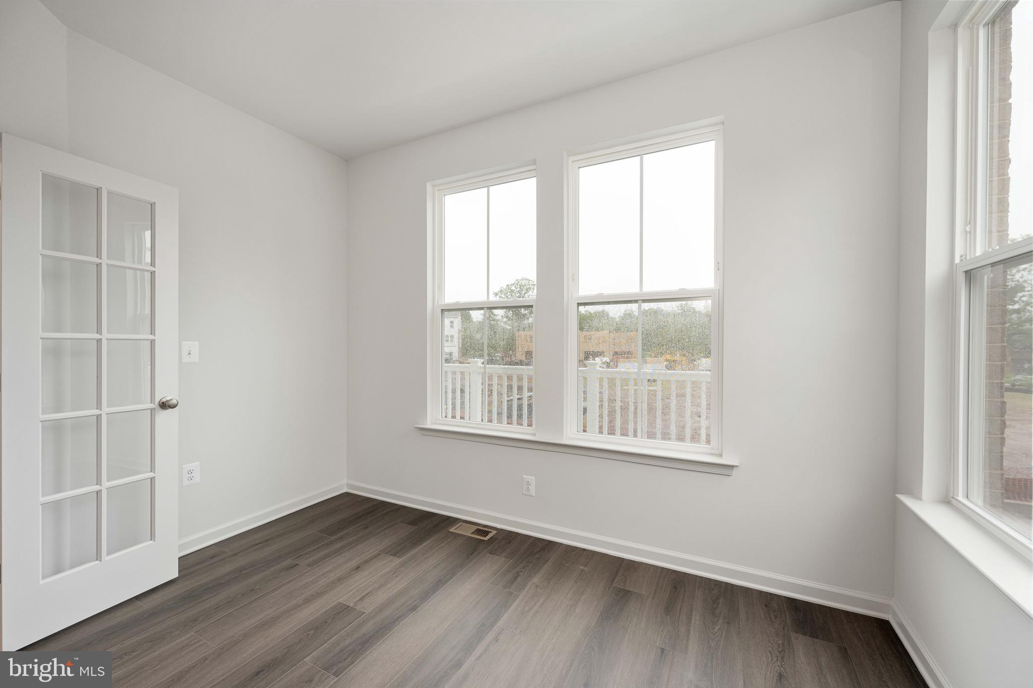 10114 Queens Way Manassas, VA 20110 - Photo 30 of 56 an empty room with wooden floor and windows