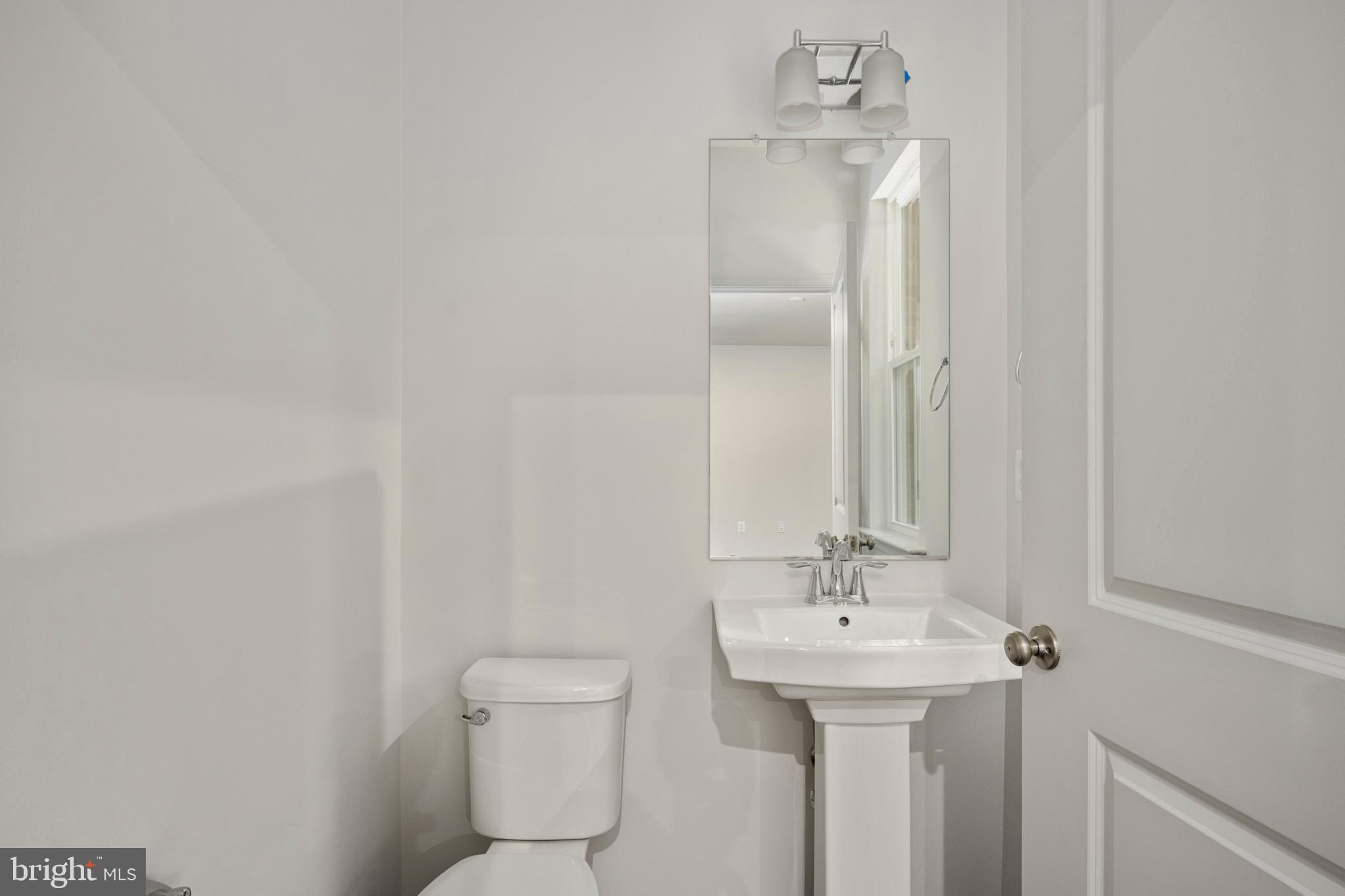 10114 Queens Way Manassas, VA 20110 - Photo 31 of 56 a bathroom with a sink a toilet and mirror