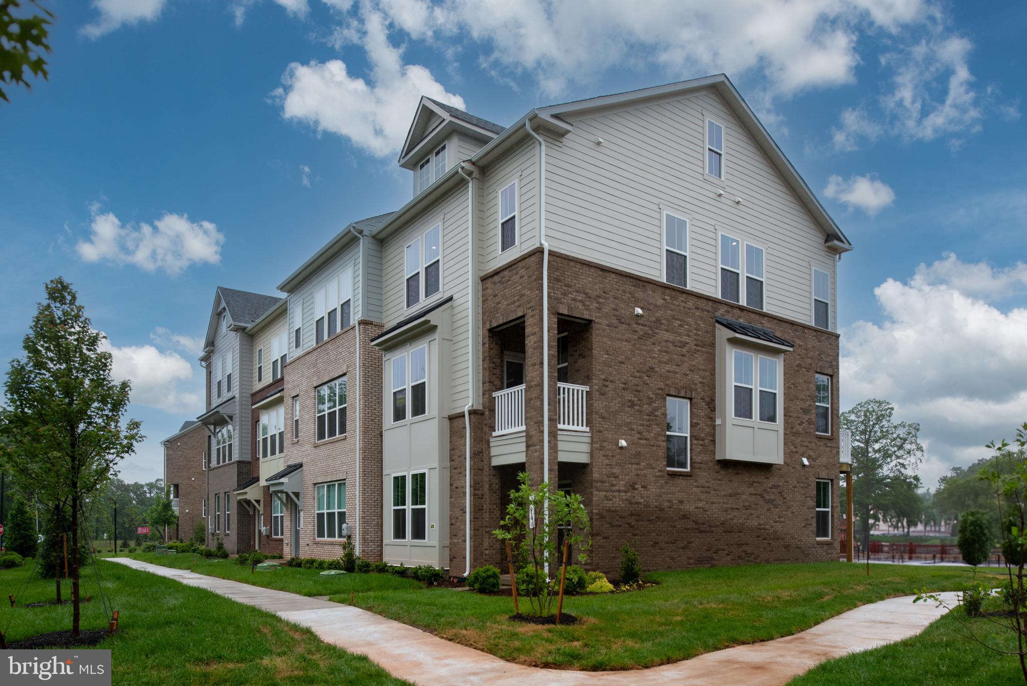 10114 Queens Way Manassas, VA 20110 - Photo 4 of 56 a view of a white house next to a yard