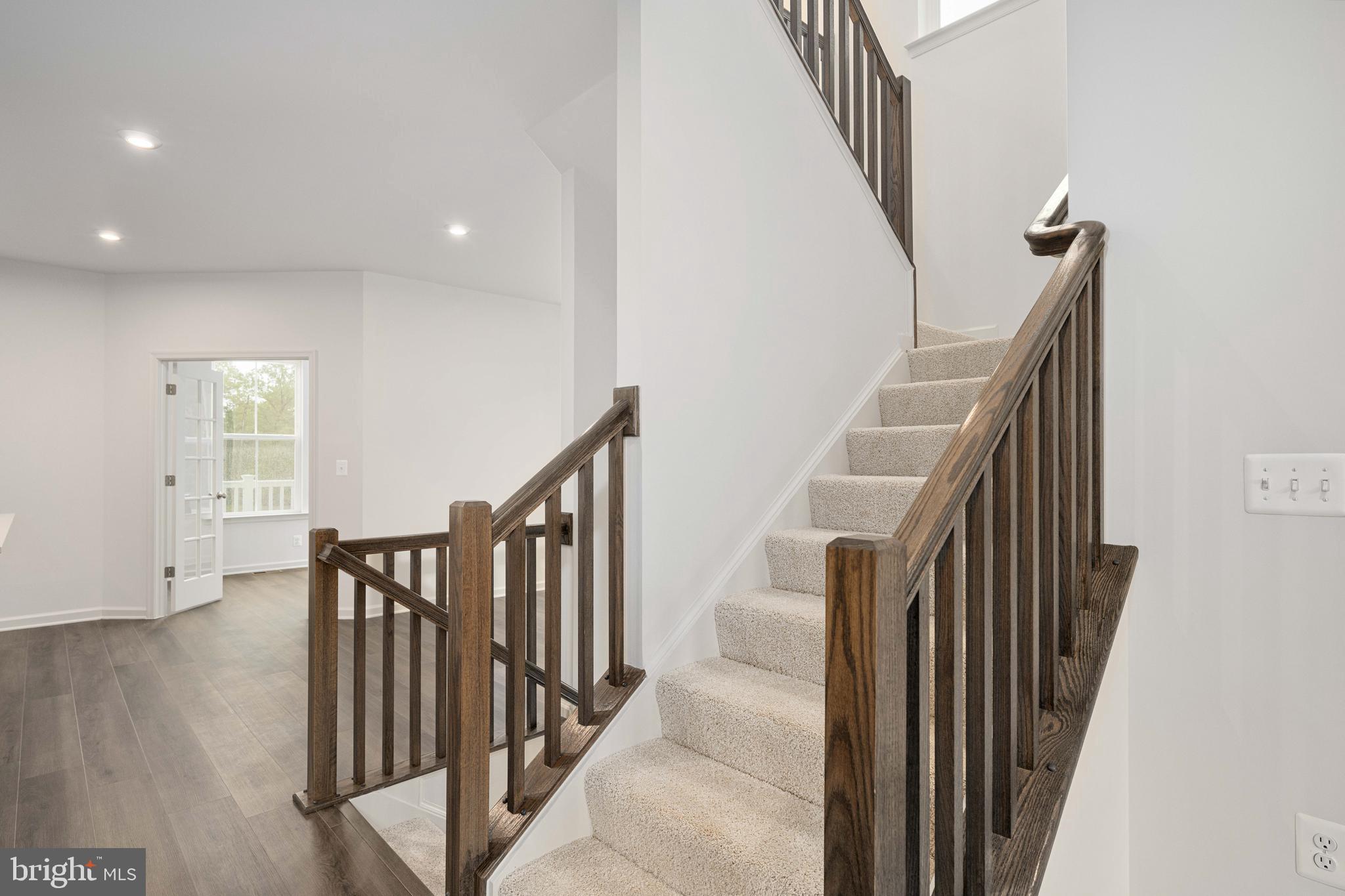 10114 Queens Way Manassas, VA 20110 - Photo 44 of 56 a view of a hallway with wooden floor and stairs