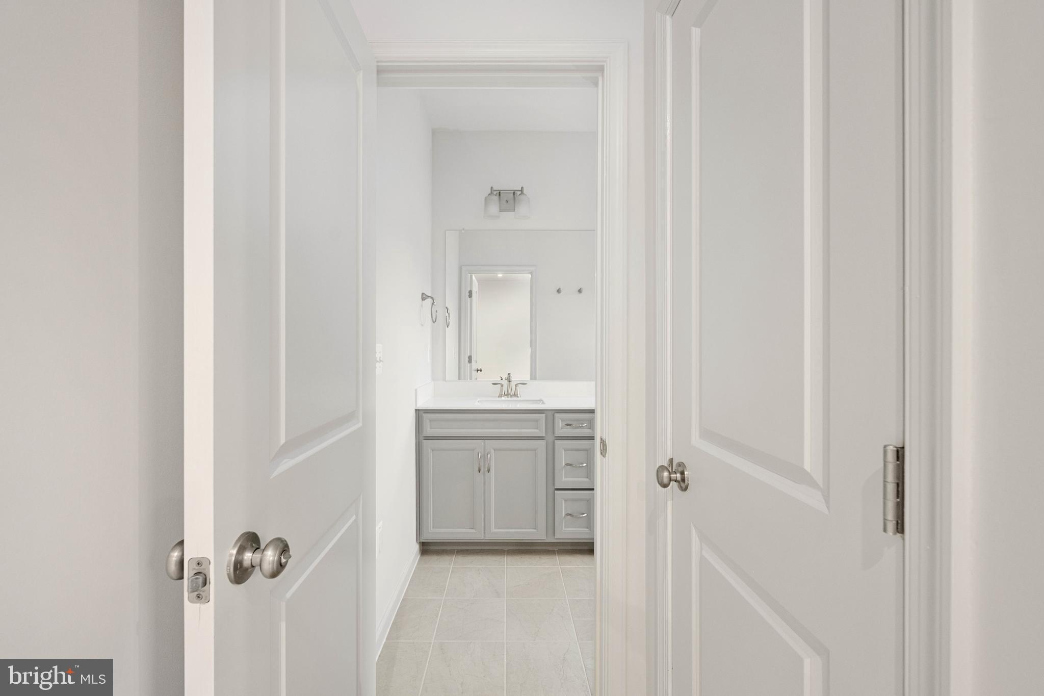 10114 Queens Way Manassas, VA 20110 - Photo 48 of 56 a bathroom with a granite countertop sink a mirror and a vanity