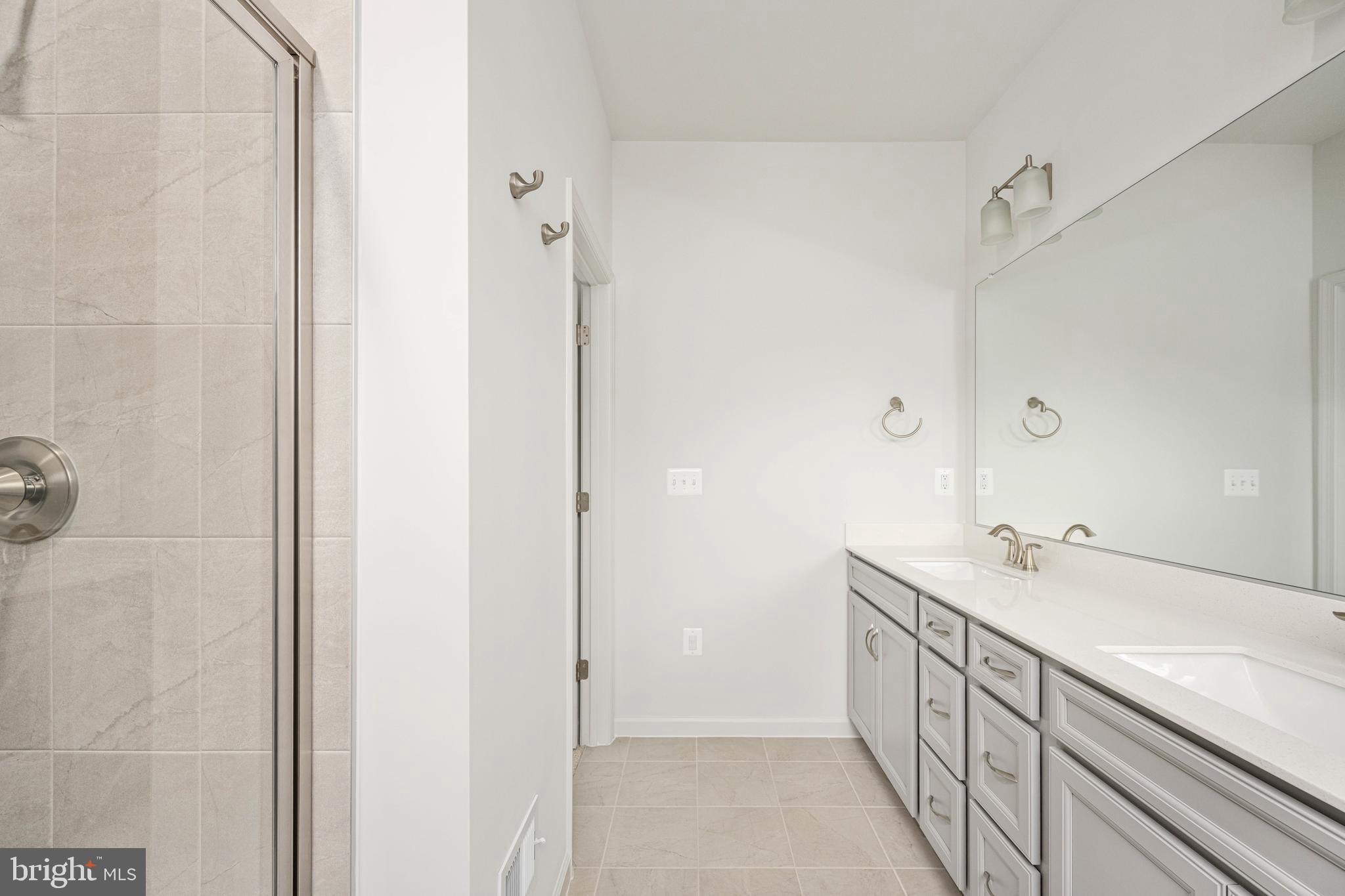 10114 Queens Way Manassas, VA 20110 - Photo 50 of 56 a bathroom with a sink and mirror