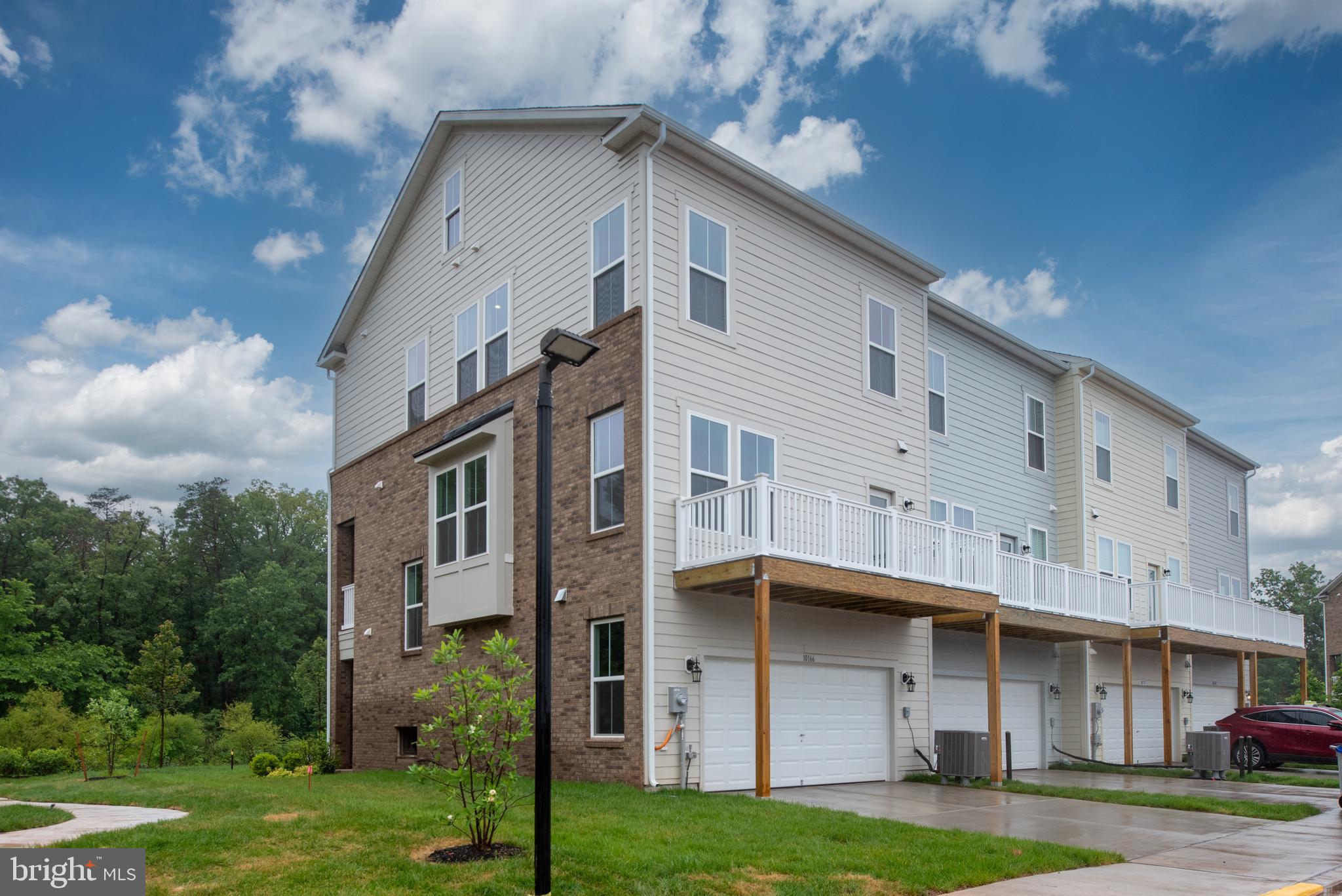 10114 Queens Way Manassas, VA 20110 - Photo 5 of 56 a front view of a building with a garden