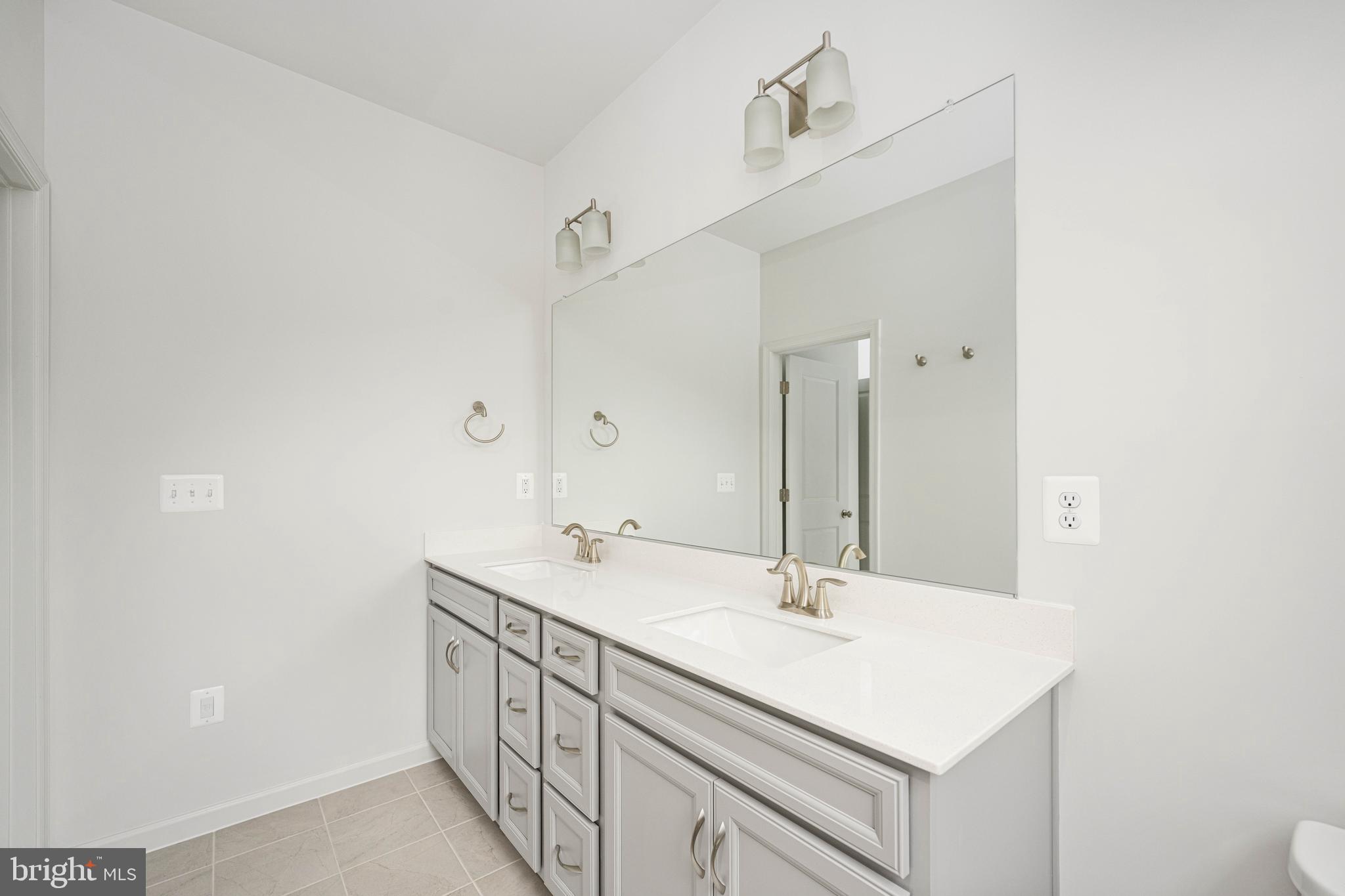 10114 Queens Way Manassas, VA 20110 - Photo 51 of 56 a bathroom with a sink a vanity and a mirror