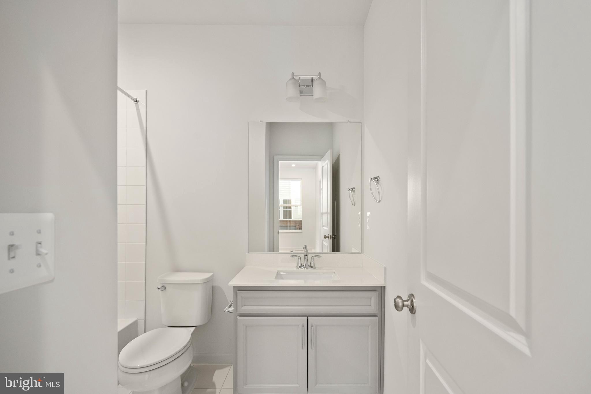 10114 Queens Way Manassas, VA 20110 - Photo 54 of 56 a bathroom with a toilet sink and mirror