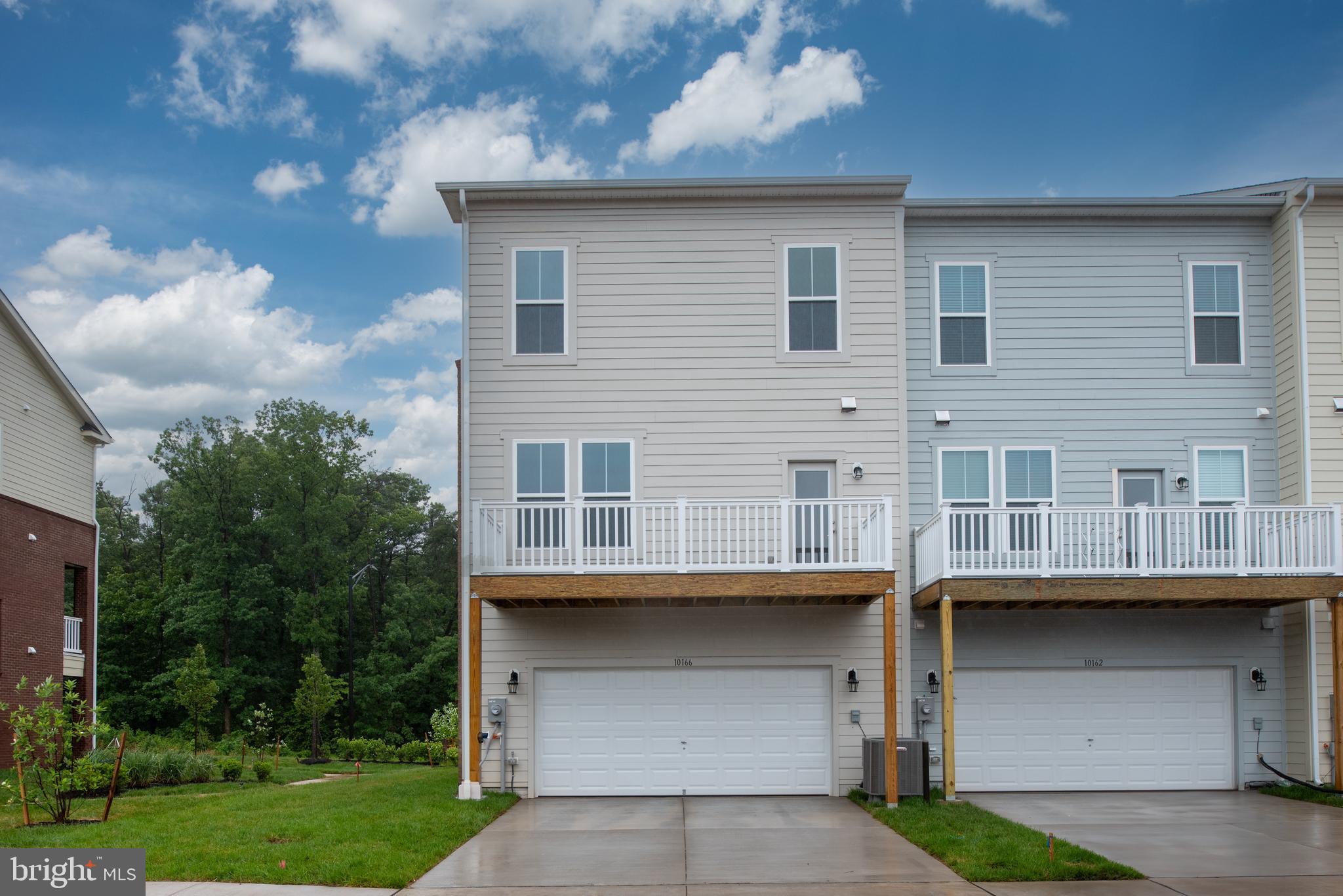 10114 Queens Way Manassas, VA 20110 - Photo 6 of 56 a view of a house with a yard and large windows