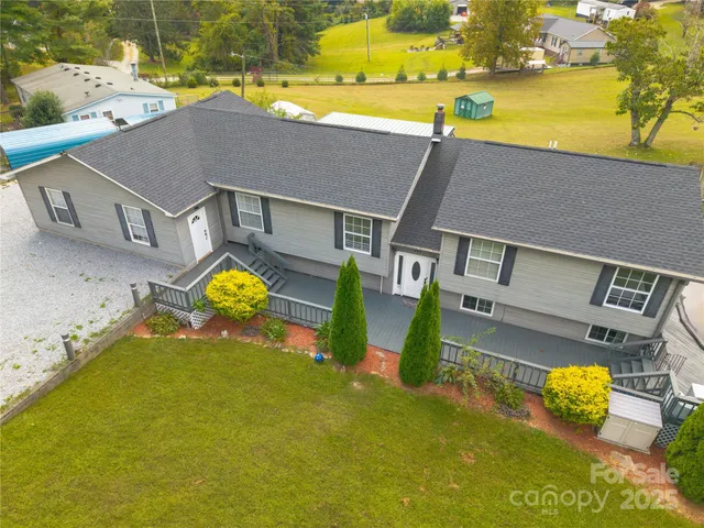 an aerial view of a house with a swimming pool