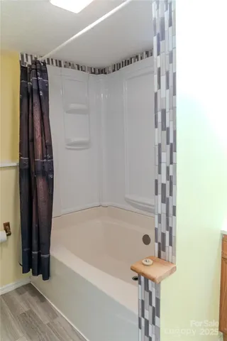 a bathroom with a bathtub and a shower