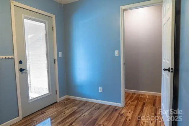 an empty room with windows and closet