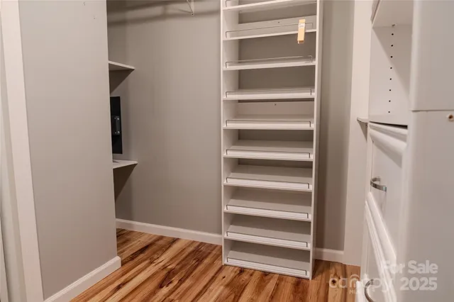 a view of walk in closet with empty racks