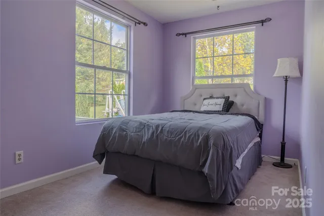 a spacious bedroom with a bed and a window