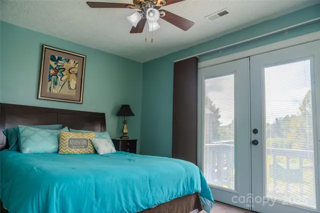 a bedroom with a bed and a chandelier