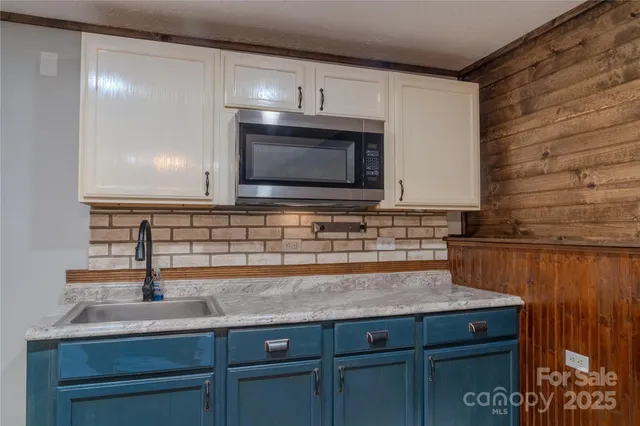 a kitchen with granite countertop a sink and cabinets