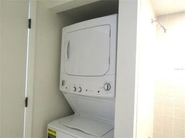 a white toilet sitting next to a white sink