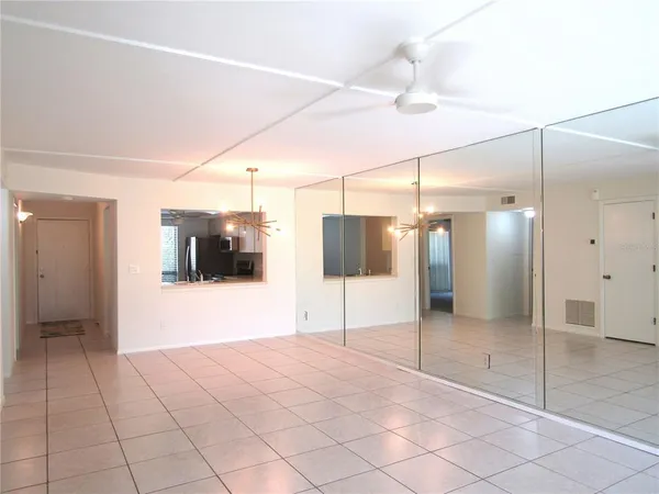 a view of a bathroom with a shower and a room