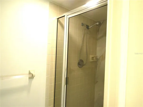 a bathroom with a shower and a glass door