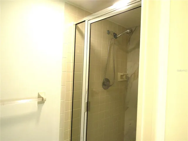 a bathroom with a shower and a glass door
