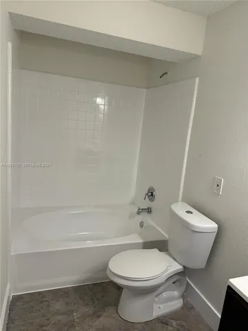 a bathroom with a toilet and a bathtub