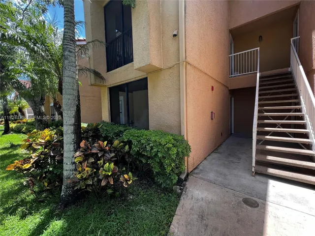 a view of a house with a flower garden