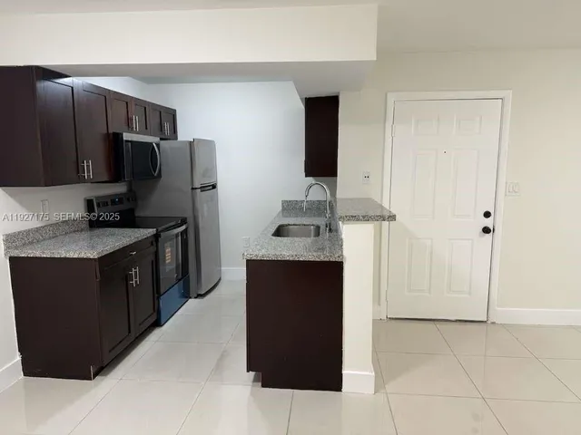 a kitchen with stainless steel appliances a refrigerator and a stove