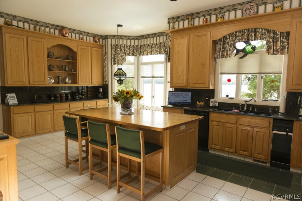 722 Point Anne Drive Hartfield, VA 23071 - Photo 18 of 21 a kitchen with a sink and chairs