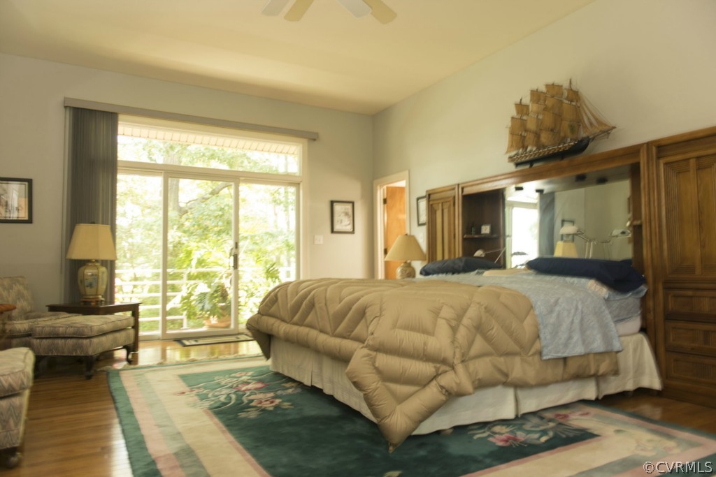 722 Point Anne Drive Hartfield, VA 23071 - Photo 19 of 21 a spacious bedroom with a bed and glass walk in closet