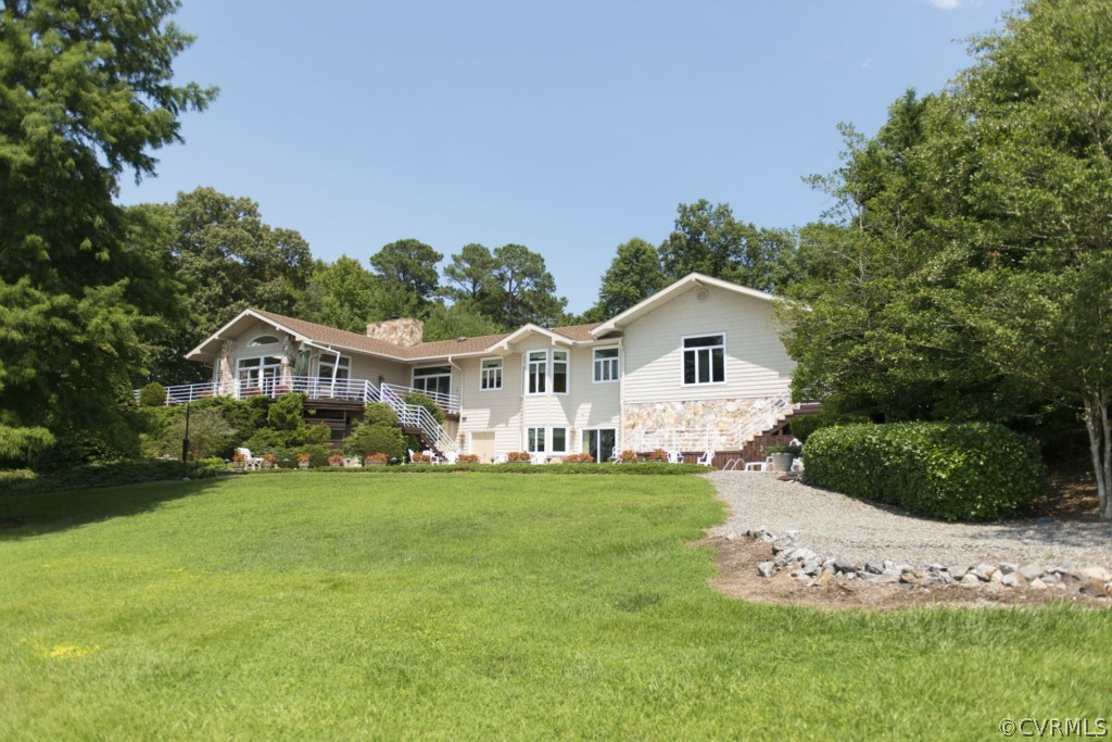 722 Point Anne Drive Hartfield, VA 23071 - Photo 6 of 21 a front view of a house with a garden and yard