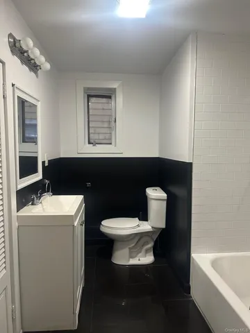 a bathroom with a toilet a sink and bathtub