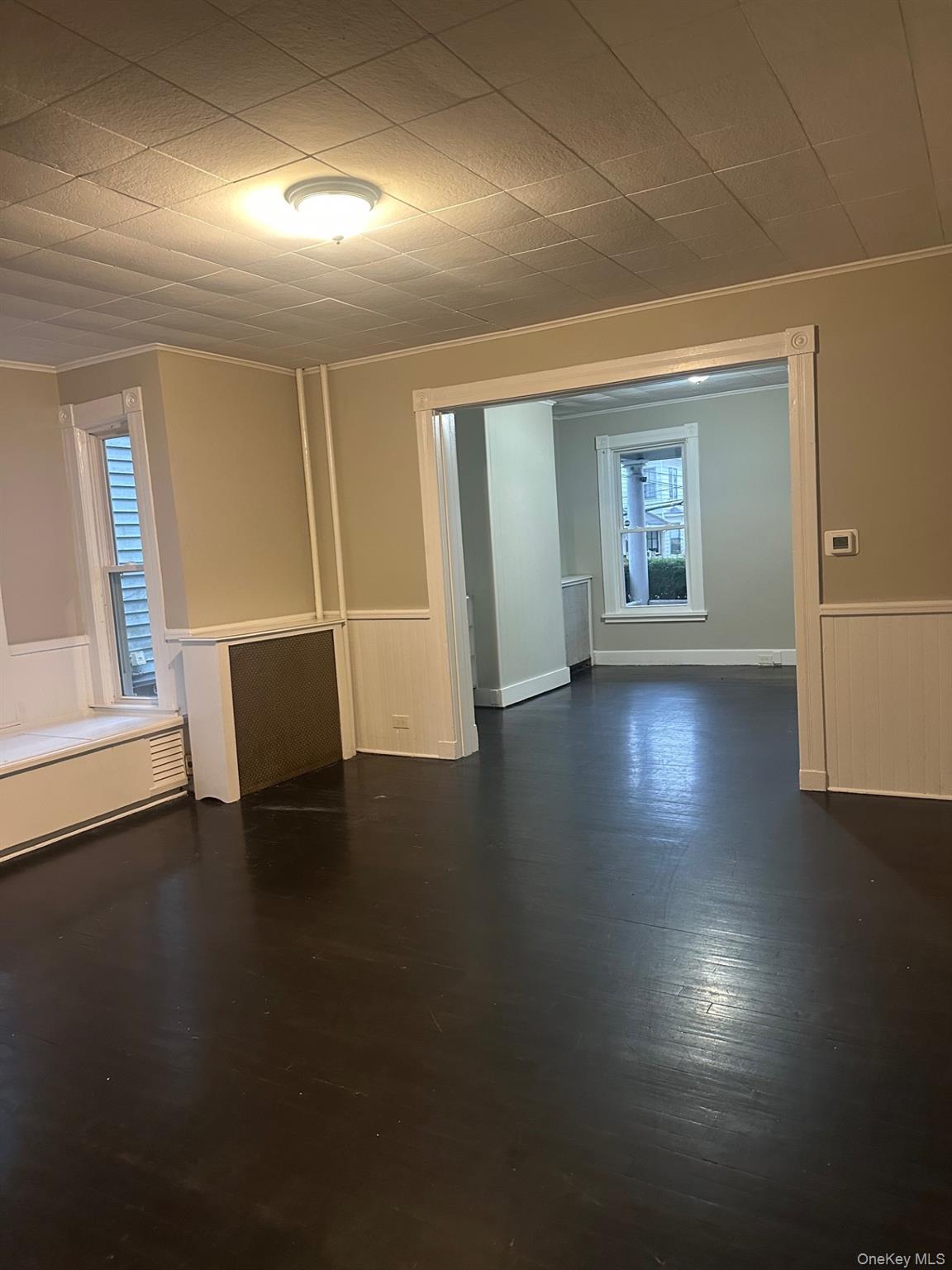 25 Virginia Avenue, Unit 1 Poughkeepsie, NY 12601 - Photo 6 of 11 an empty room with wooden floor and windows