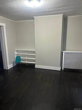 a view of room with wooden floor