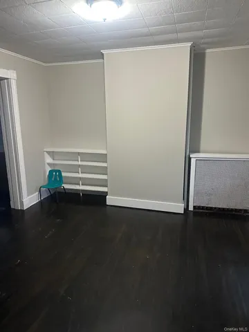 a view of room with wooden floor