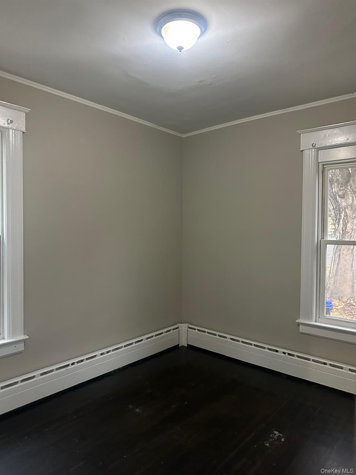 25 Virginia Avenue, Unit 1 Poughkeepsie, NY 12601 - Photo 8 of 11 a view of an empty room with wooden floor and a window