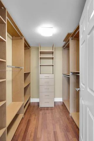 a kitchen with stainless steel appliances granite countertop a refrigerator and a stove