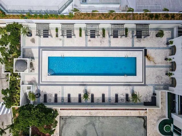 a view of a balcony with chairs and potted plants